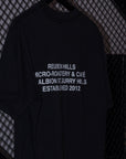Black t-shirt with white text on a textured black background